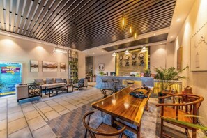 A modern interior with a wooden dining table, chairs, and a bar area. - Chongqing Aisi Business Hotel (Chongqing)