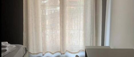 A room with a bed, a table, and a chair.
