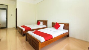 A hotel room with two wooden beds, each with a red and white bedspread and pillows. - Cua Dai Beach Hotel (Da Nang)