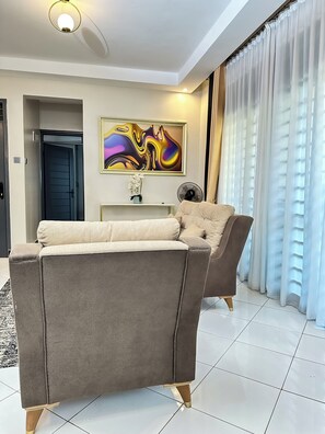 Comfort Apartment, Balcony, City View | Living area | Flat-screen TV - LivLuxe Apartments 3 (Kampala)