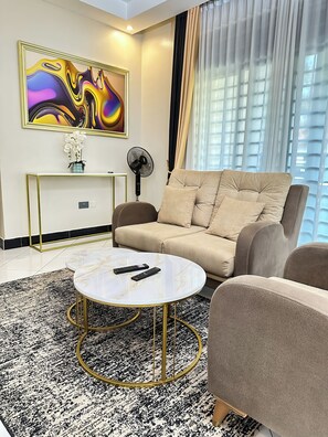 컴포트 아파트, 발코니, 시내 전망 | 거실 공간 | 평면 TV