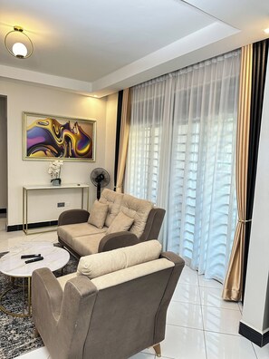 Comfort Apartment, Balcony, City View | Living area | Flat-screen TV - LivLuxe Apartments 3 (Kampala)