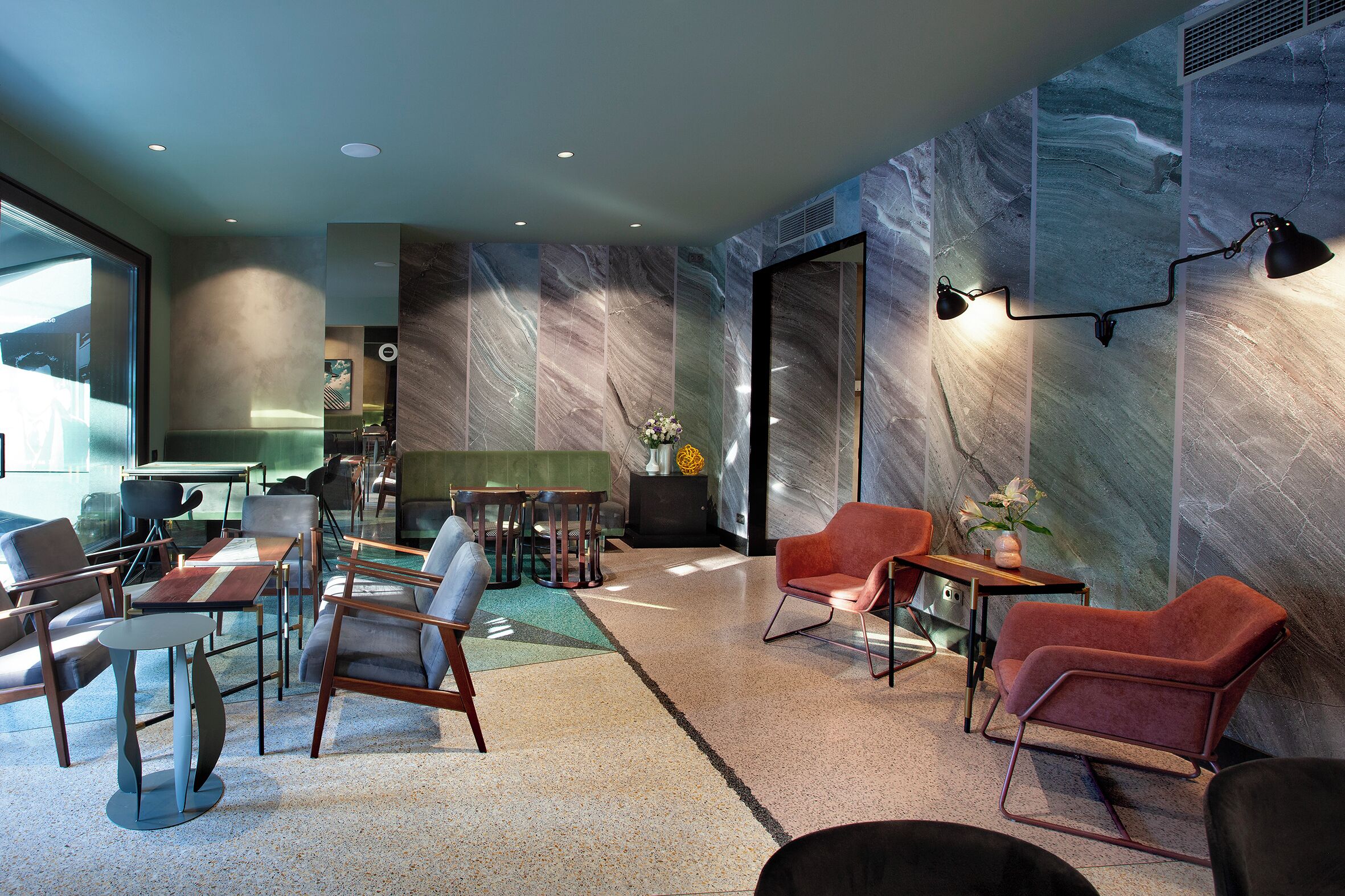 A modern lounge area with seating arrangements, a coffee table, and a decorative vase.