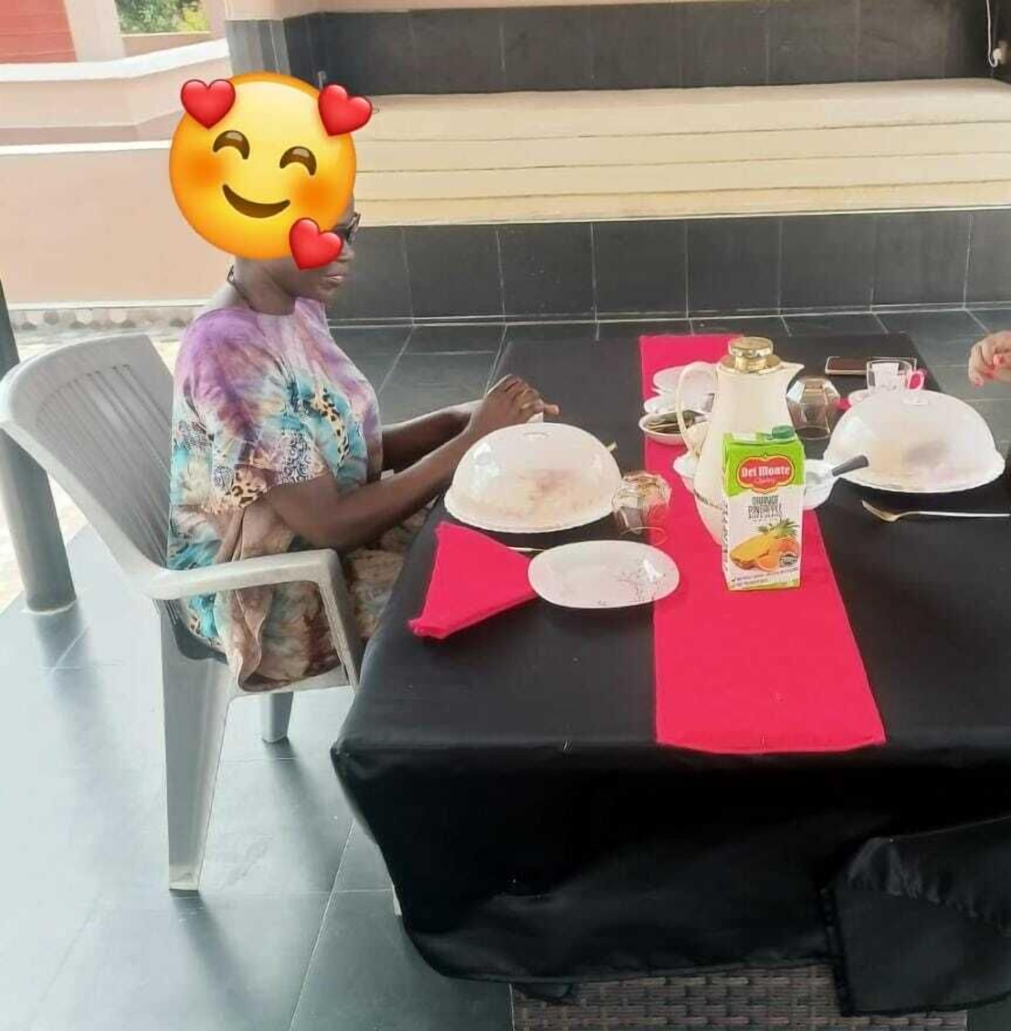 A dining table set with plates, a bottle, and a glass.