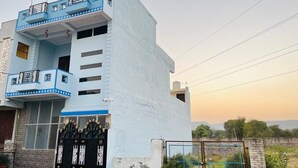 A multi-story building with a blue and white facade, a gated entrance, and a balcony with railings. - Bhanu Bhawan (Jaipur)