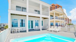 A multi-story hotel with a rooftop pool area, outdoor seating, and balconies. - Orange Beach House East Beach Front, Private Pool, Sleeps up to 28, Quiet Beach! (Orange Beach)