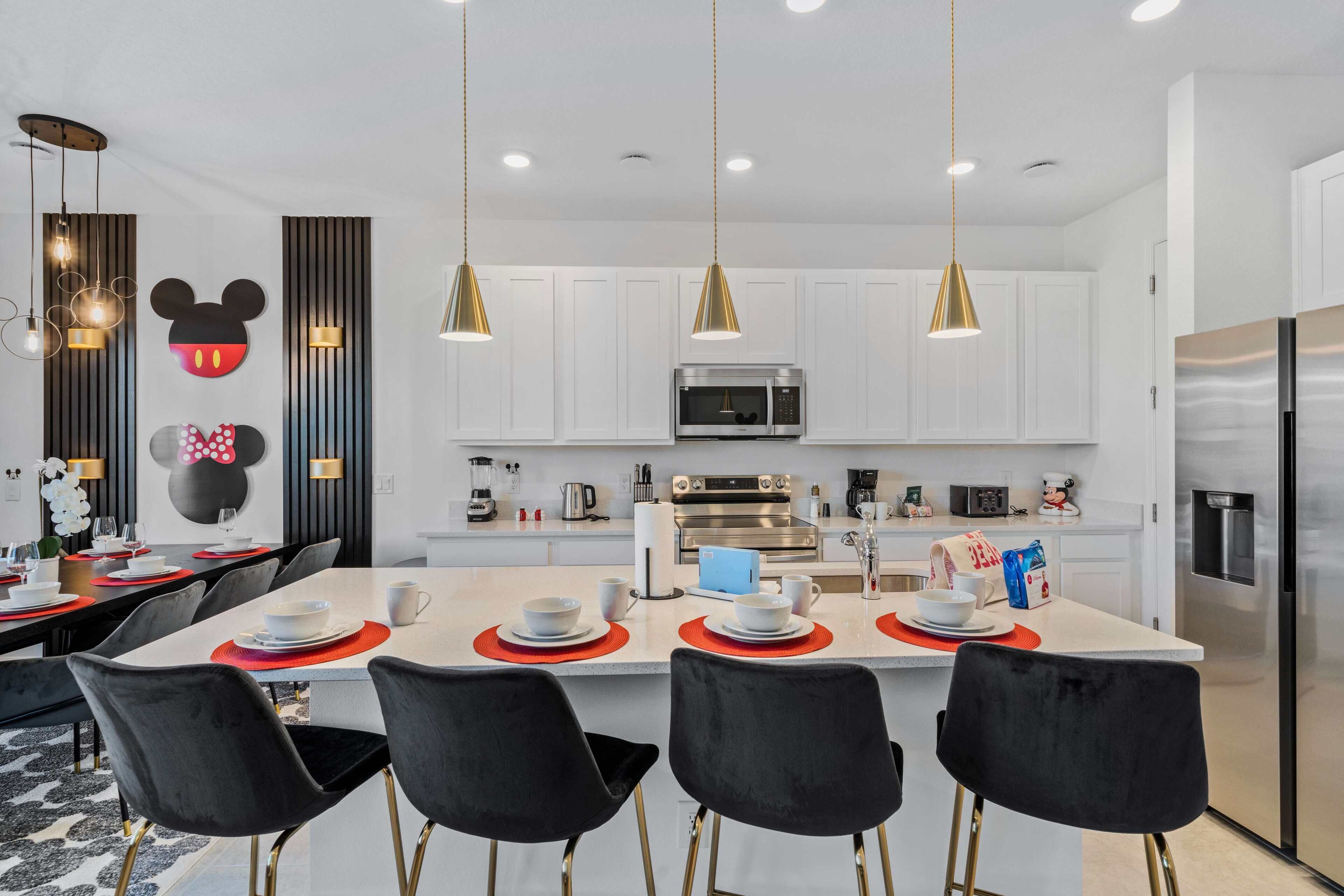 A modern kitchen with white cabinets, stainless steel appliances, and a central island with seating.