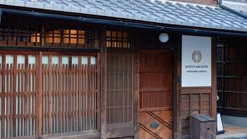 A traditional Japanese building with a tiled roof and wooden sliding doors.