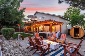 A patio area with outdoor seating and a fire pit. - Luxury! Hot Tub•Sauna•Miniputt•GameRoom•Pets (Boise)