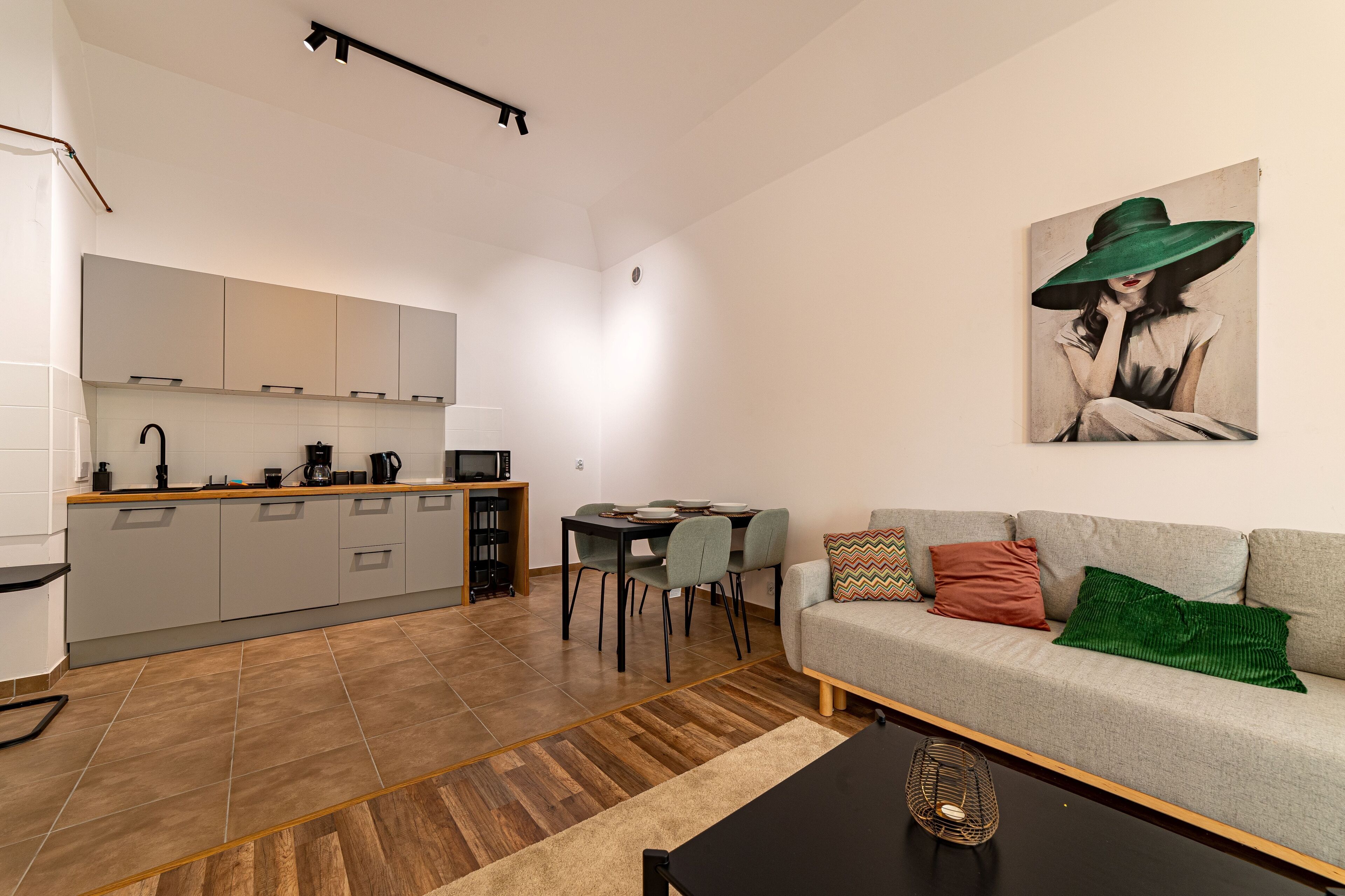 A modern apartment with a kitchen, dining area, and living room.