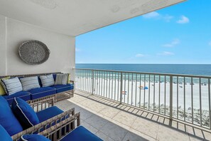A balcony with a view of the beach and ocean. - Admirals Quarters 703-New-Custom Decorated-Built-in Bunks-Beachfront-Luxury-View (Orange Beach)