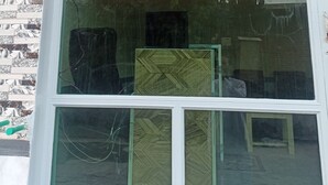 A reception window with the text "CHANDI HOTEL RECEPTION" in red letters.