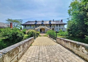 Stately historic building with a central entrance and symmetrical facade.
