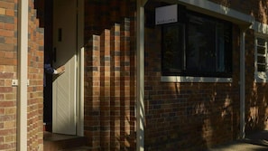 A brick building with a sign reading 'MARLOWE' above a window.