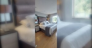 A modern bedroom with a large bed, bedside tables, and a window providing natural light.