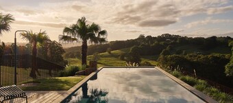 Myocum Ridge Farm - A winding driveway, cows, blue skies, manicured lawns, glittering pool