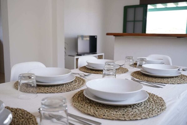 Enjoy meals in a comfortable setting with a neatly set table for four.