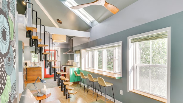 A modern kitchen with a dining area, large windows, and a loft-style ceiling. - 3 Mi to Boothbay Harbor: Coastal Colorful Home! (East Boothbay)