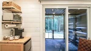 A kitchen with a coffee maker, microwave, and shelves with kitchenware. - Nashwauk Studio w/ Ice Fishing on South Fork Lake (Nashwauk)