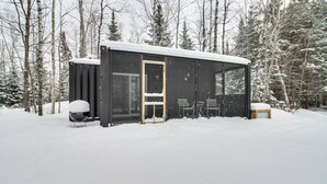 A modern cabin with a glass door, a small porch, and a bench. - Ice Fish on South Fork Lake From Nashwauk Studio (Nashwauk)