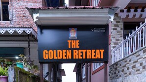 A narrow alleyway leading to a building with a sign for "The Golden Retreat." - The Golden Retreat Hotel in Pelling (Gyalshing)