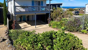 A two-story house with a balcony, a garage, and a view of the ocean. - Seaview at the Bay - Wi-Fi and Linen Included (Encounter Bay)