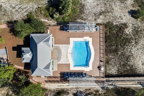 An aerial view of a resort with a swimming pool, sun loungers, and a covered area. - Loft with Game Room | Pool Access (Port St. Joe)