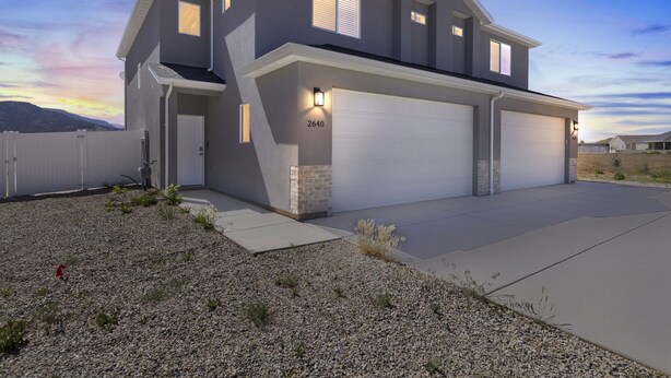 A modern two-story house with a garage, numbered 2640, and a driveway leading to the entrance.