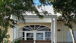 A wooden bridge leading to a house with a covered porch and a wooden deck. - Big Hill - a luxurious haven that will not disappoint, View Sunrise, Dock (Elbow Cay)