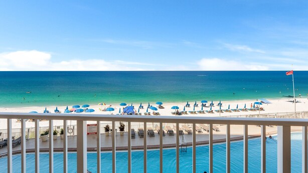 A beach view with a pool and lounge chairs. - Beachfront resort condo w/ Gulf balcony views (Panama City Beach)