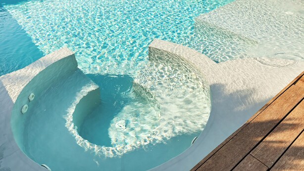 A clear blue pool with a wooden deck and a concrete edge. - Villa Tiberio 6+2, Emma Villas (Genzano di Roma)