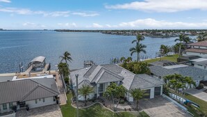 A residential area with houses, a marina, and a clear view of the water.