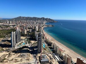 A coastal cityscape with high-rise buildings, a beach, and a clear blue sky. - Apartments in Intempo by Leo Apartments (Benidorm)