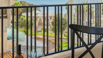 Enjoy a romantic evening on this oceanfront balcony with a table set for two, complete with wine, fruit, and a comfortable chair.