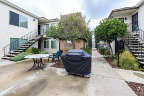 Enjoy al fresco dining on the covered grill and balcony with a beautiful view of the landscaped surroundings.