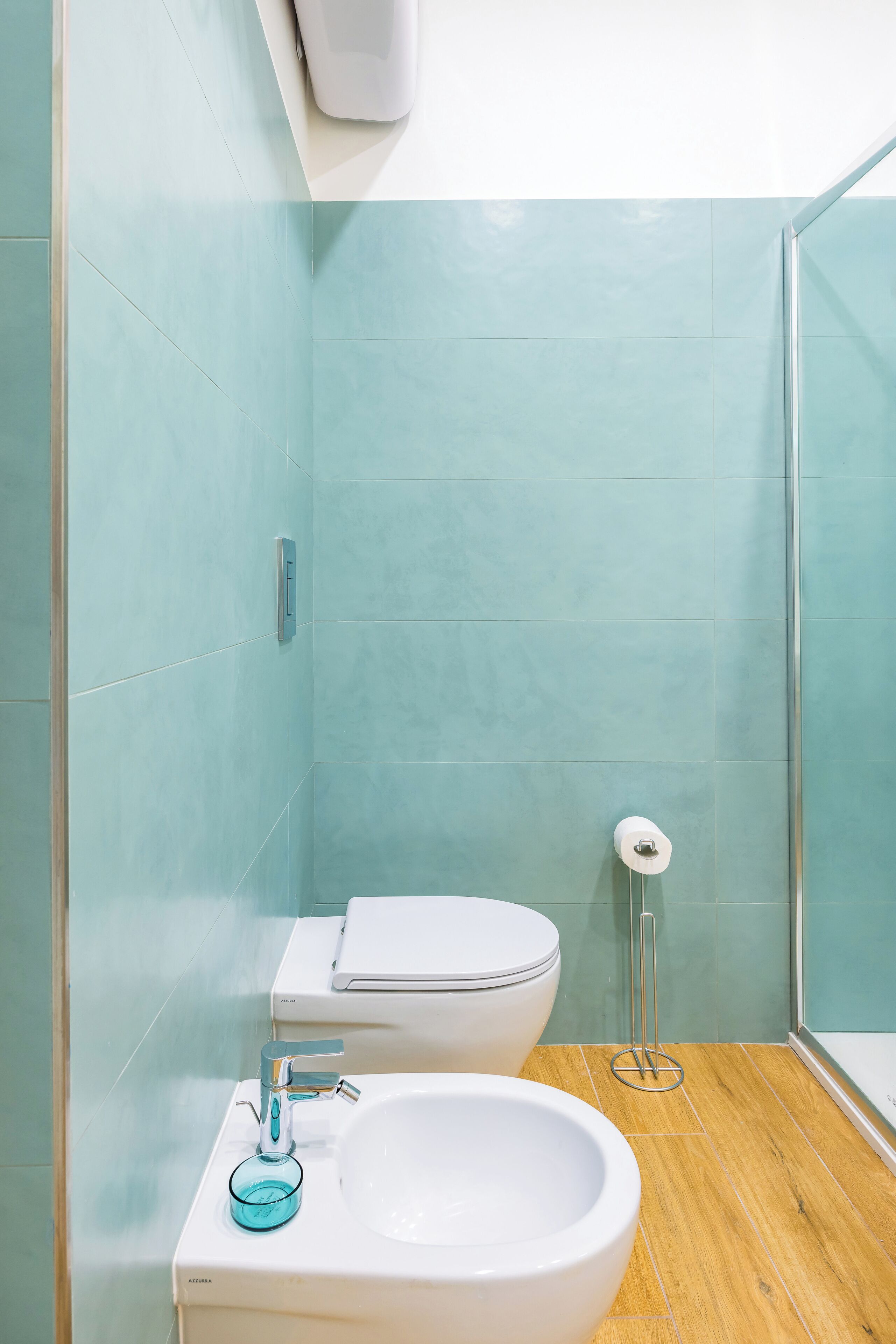 A bathroom with a toilet, bidet, and sink.