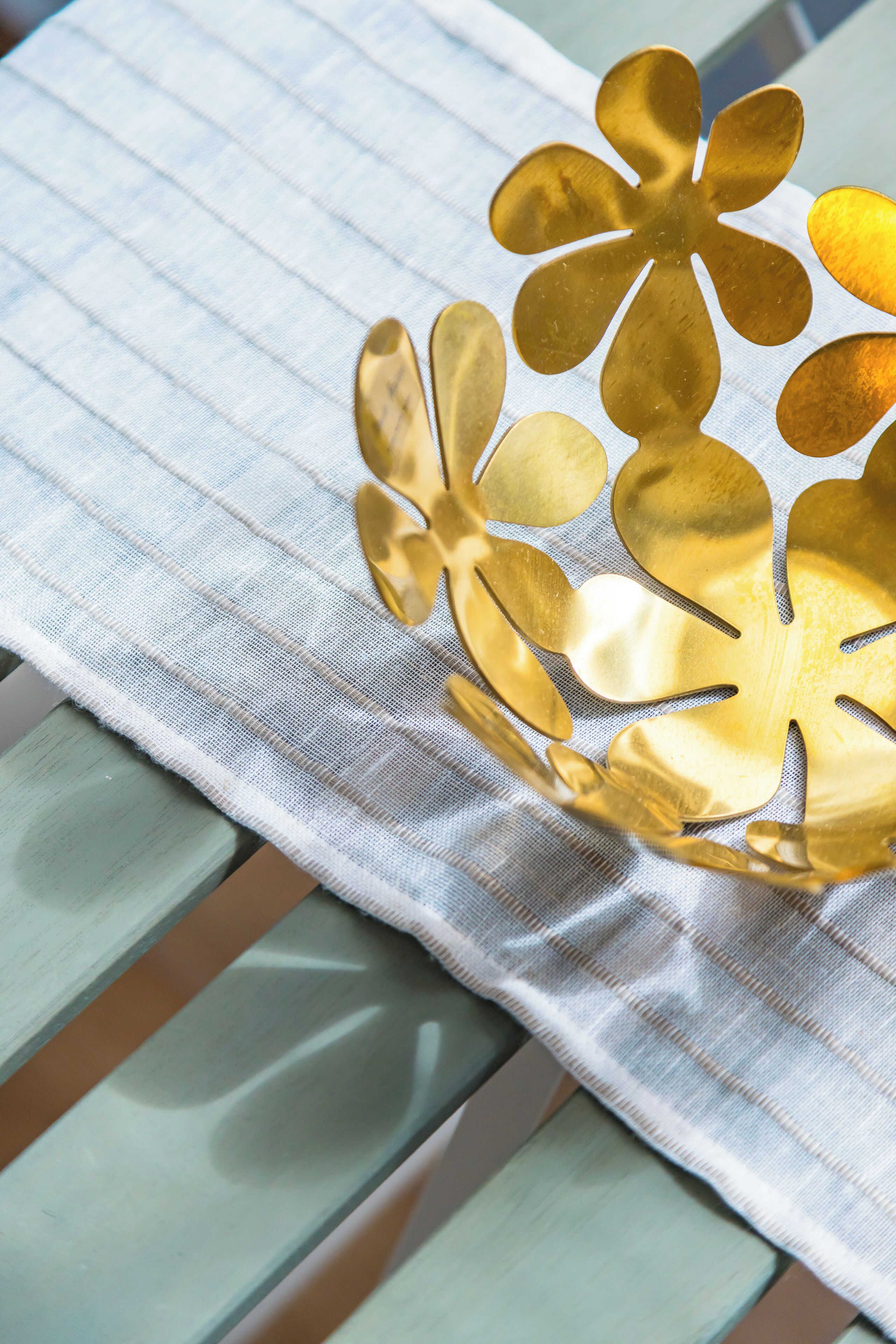 A decorative golden object on a striped fabric surface.
