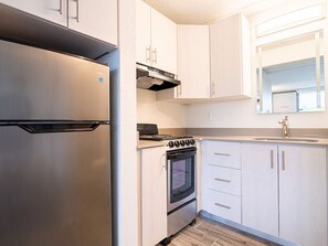 Fridge, coffee/tea maker, cookware/dishes/utensils, dining tables
