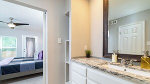 A bedroom with a bed, a ceiling fan, and a window with blinds. - Patio + Covered Terrace - Steps to TCU (Fort Worth)