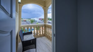 A balcony with a view of a parking lot and buildings. - Island Dreams Villa at Legacy Townhouse (Montego Bay)