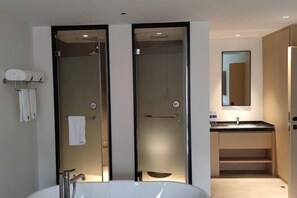 A modern bathroom with a large white sink, a glass-enclosed shower, and a mirror above the sink. - Ruian Zhailiaoxi Hotel (Rui'an)