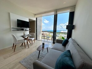 Deluxe Apartment | Living area | LED TV - Musa del Carmen By BoutiqueApartments MX (Playa del Carmen)