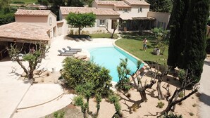 A residential property with a swimming pool, outdoor seating, and a view of the surrounding landscape. - Fantastic private villa with heated saltwater pool in Provence (Modène)