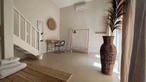 A spacious room with a wooden table, a wicker vase, a swing, and a staircase. - Fantastic private villa with heated saltwater pool in Provence (Modène)
