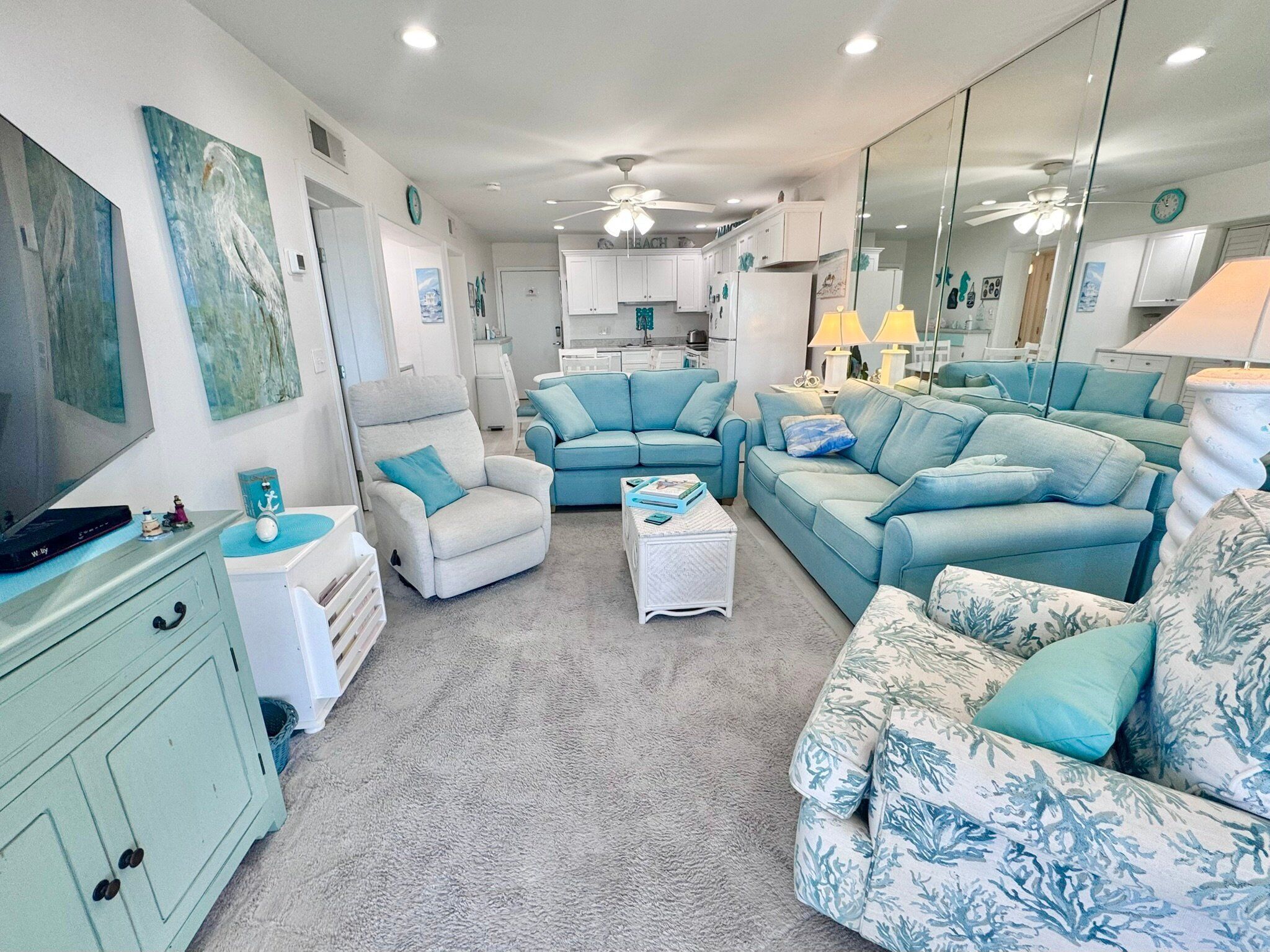 A living room with a sofa set, a chair, a coffee table, and a TV stand.