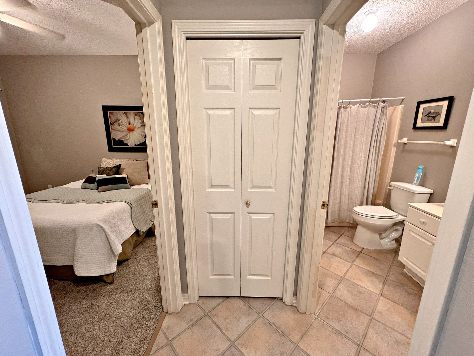 A bathroom with a toilet, sink, and shower curtain.