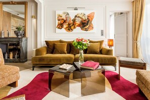 A living room with a sofa, a coffee table, and a painting on the wall.