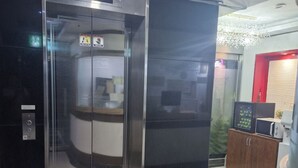 A modern elevator with a digital display, a control panel, and a glass door. - Yeon Stay (Seoul)
