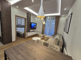 Comfort Apartment, Garden View | Living area | TV