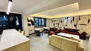 A modern living room with a sofa, a dining table, and chairs. - Rose Point Residence (Istanbul)